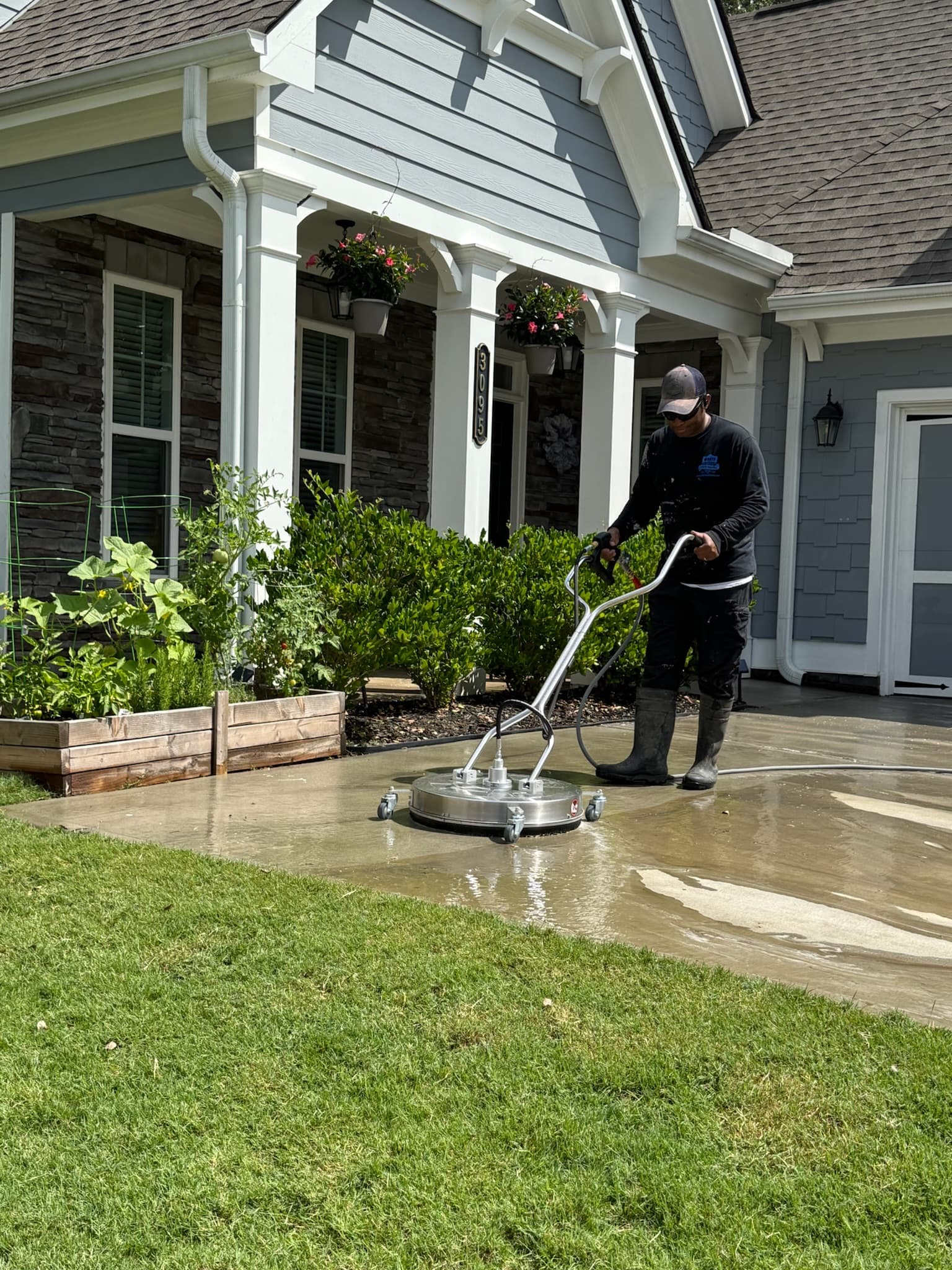 Osmany pressure washing a residential driveway in Metro Atlanta